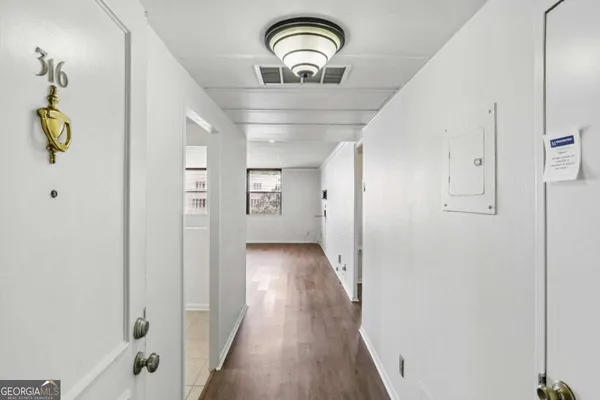 a view of a hallway with wooden floor