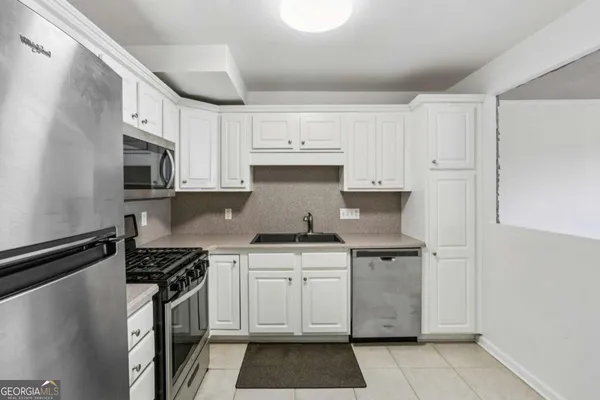 a kitchen with stainless steel appliances granite countertop a stove and a refrigerator