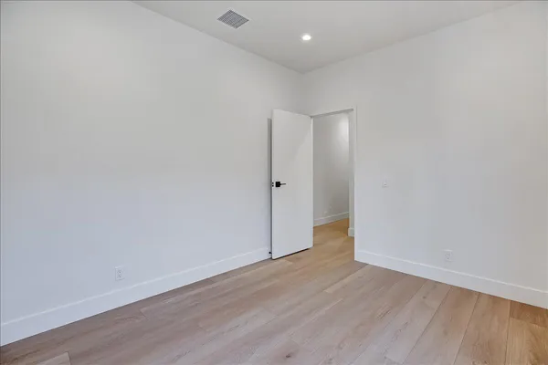 a view of an empty room with glass door