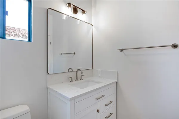 a white toilet sitting next to a window