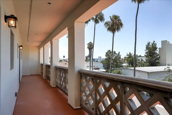 a view of a hallway to a livingroom with furniture