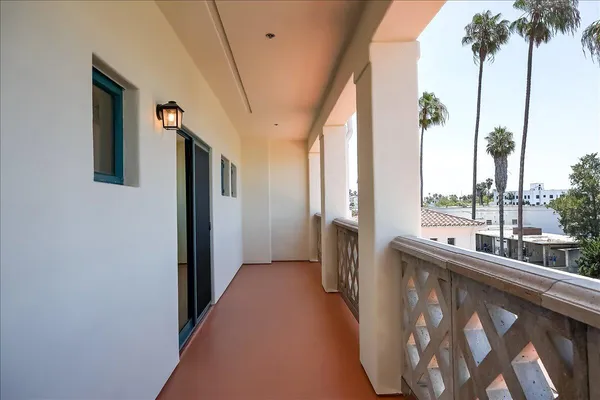 a view of a balcony with wooden floor and stairs