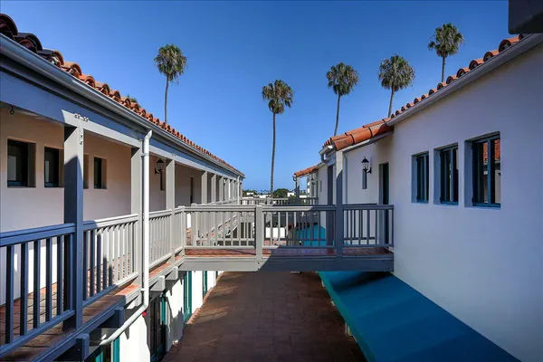 a balcony view with a potted plants wooden floor and a table