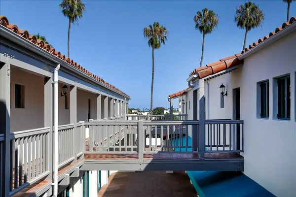 a balcony view with a wooden fence