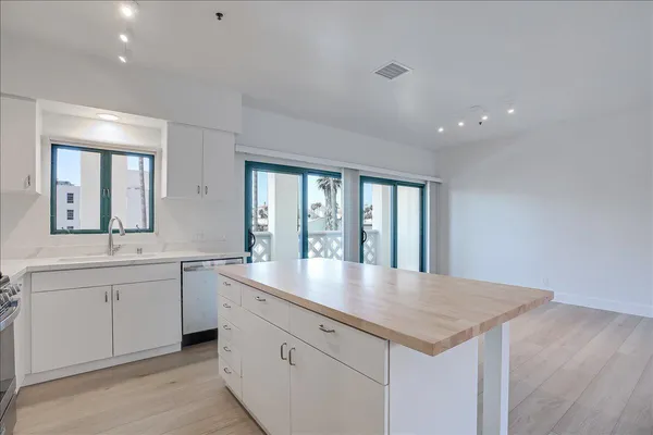 a kitchen with sink and mirror