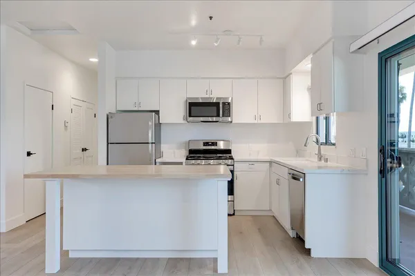 a kitchen with cabinets and a refrigerator