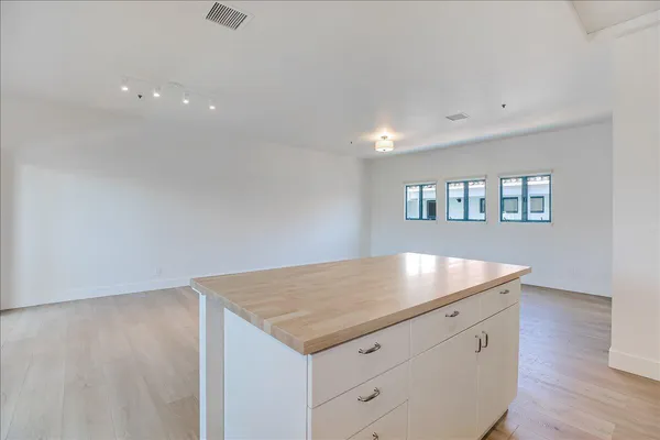 a view of kitchen with wooden floor and electronic appliances