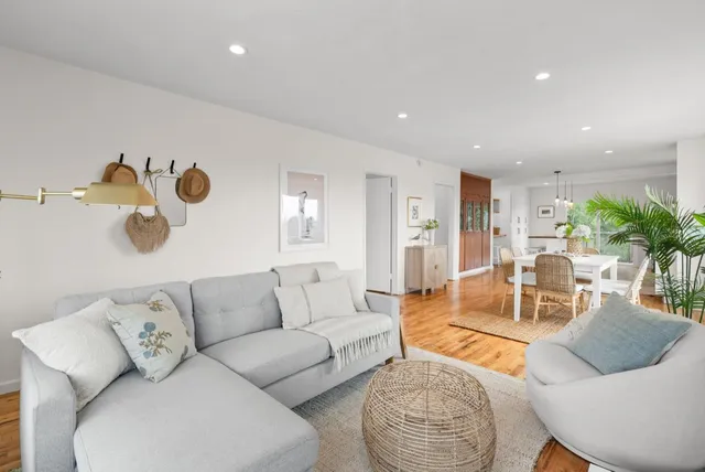 a living room with furniture and wooden floor