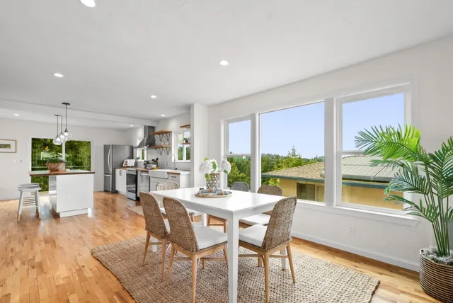 a view of a dining room with furniture window and wooden floor