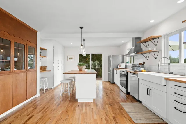a kitchen with stainless steel appliances granite countertop a stove and a sink