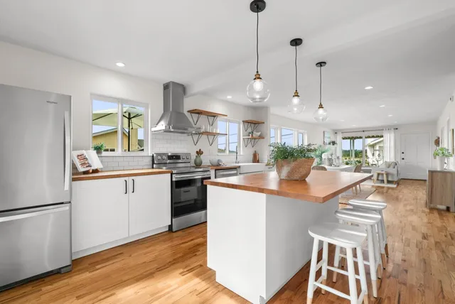 a bedroom with two beds and a large window
