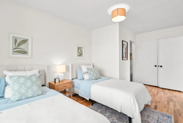 a bed room with a bed and a chair