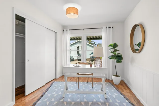 a bedroom with a bed and wooden floor