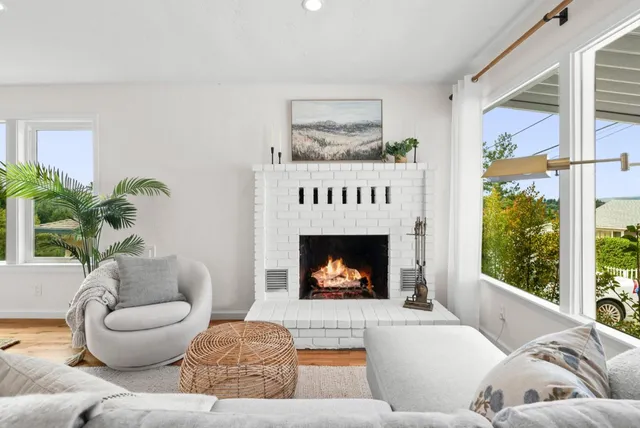 a living room with furniture a window and a fireplace