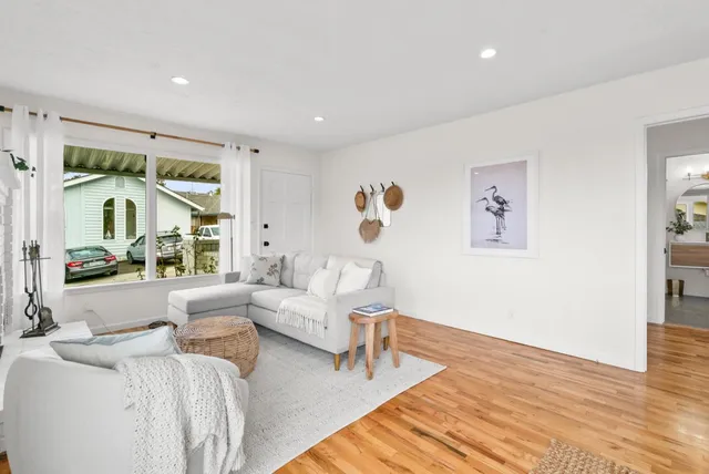 a dining room with furniture window and wooden floor