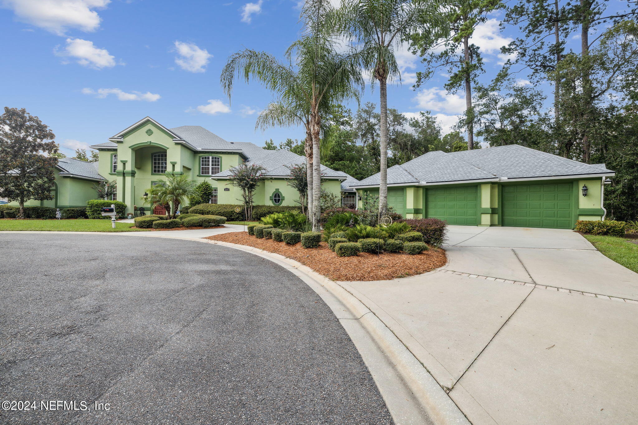 a view of a house with yard and a garage