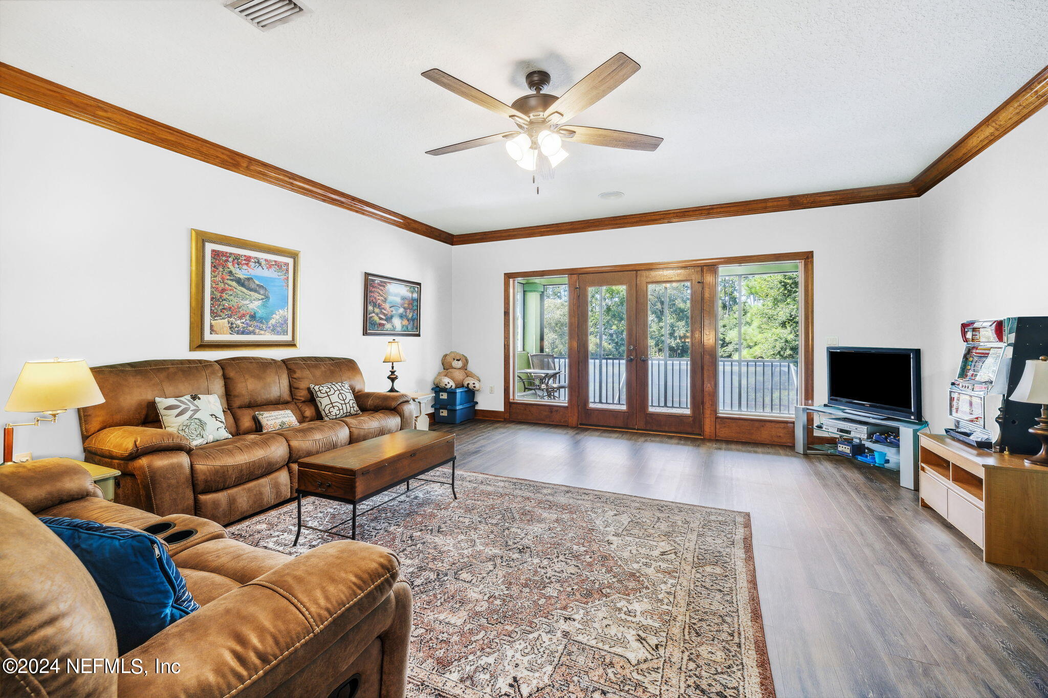 2771 Shade Tree Drive Fleming Island, FL 32003 - Photo 16 of 40 a living room with furniture flat screen tv and a large window