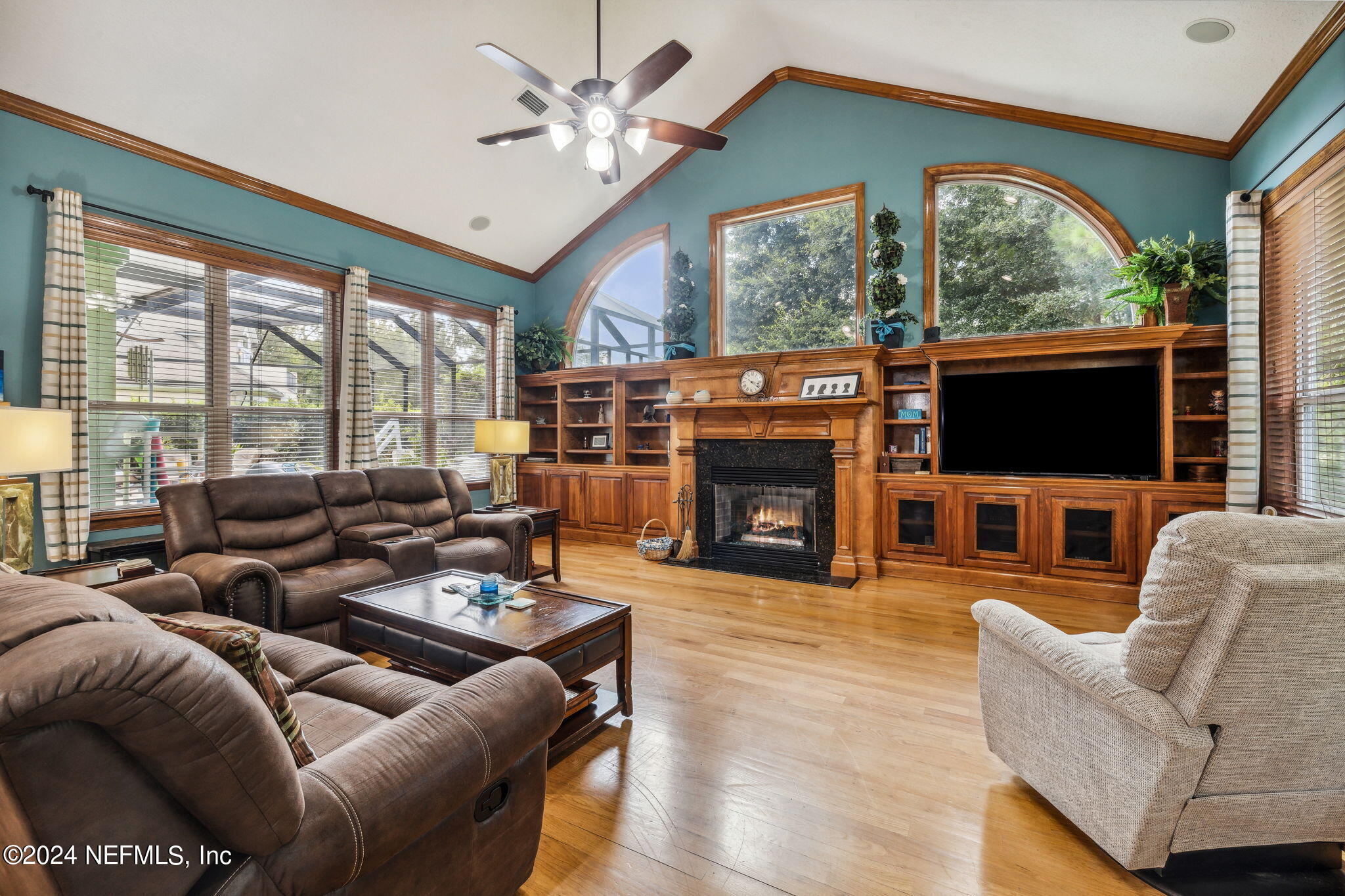 2771 Shade Tree Drive Fleming Island, FL 32003 - Photo 4 of 40 a living room with furniture a fireplace and a flat screen tv