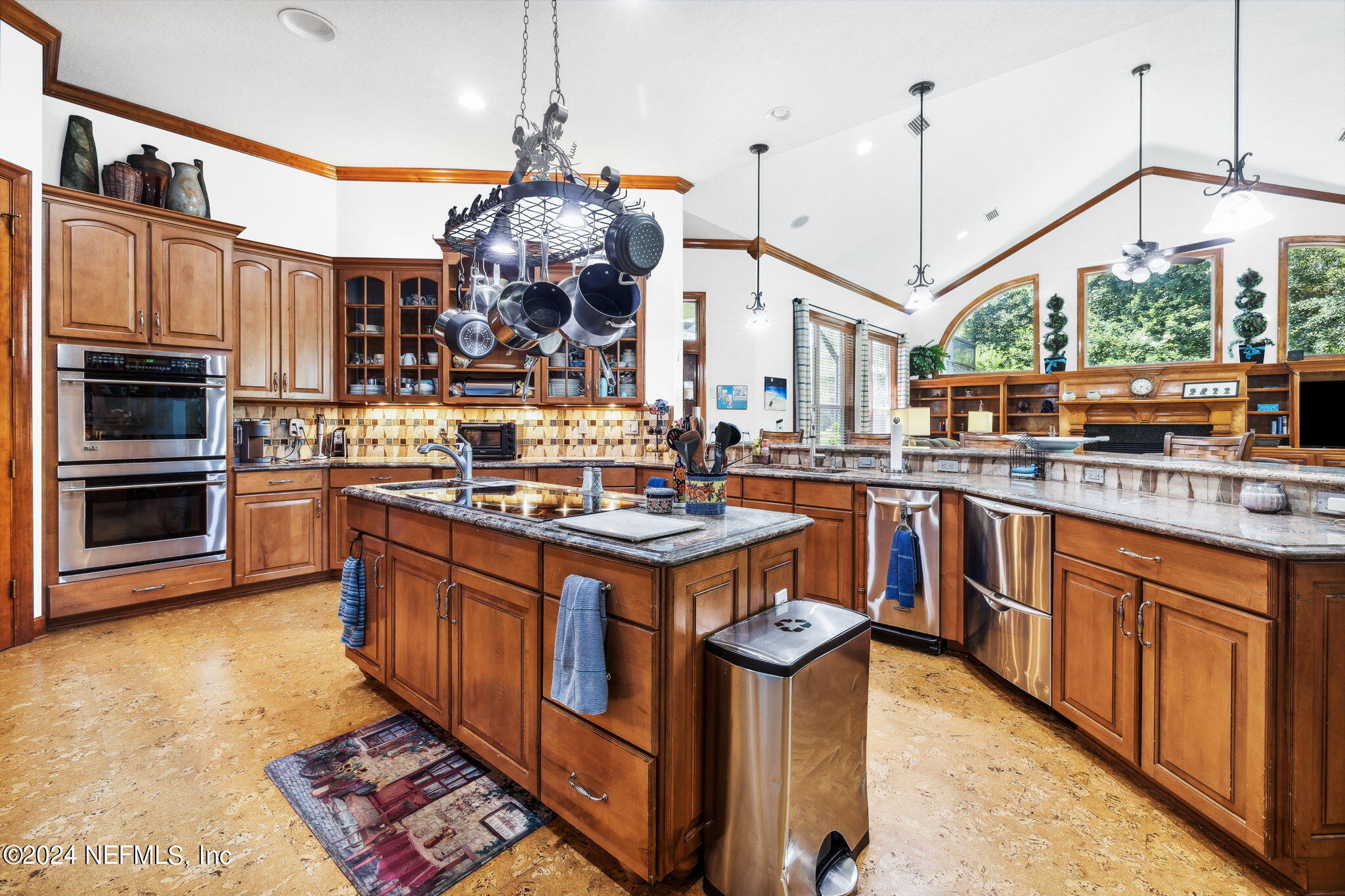 2771 Shade Tree Drive Fleming Island, FL 32003 - Photo 8 of 40 a kitchen with stainless steel appliances granite countertop a stove a sink and a wooden floors