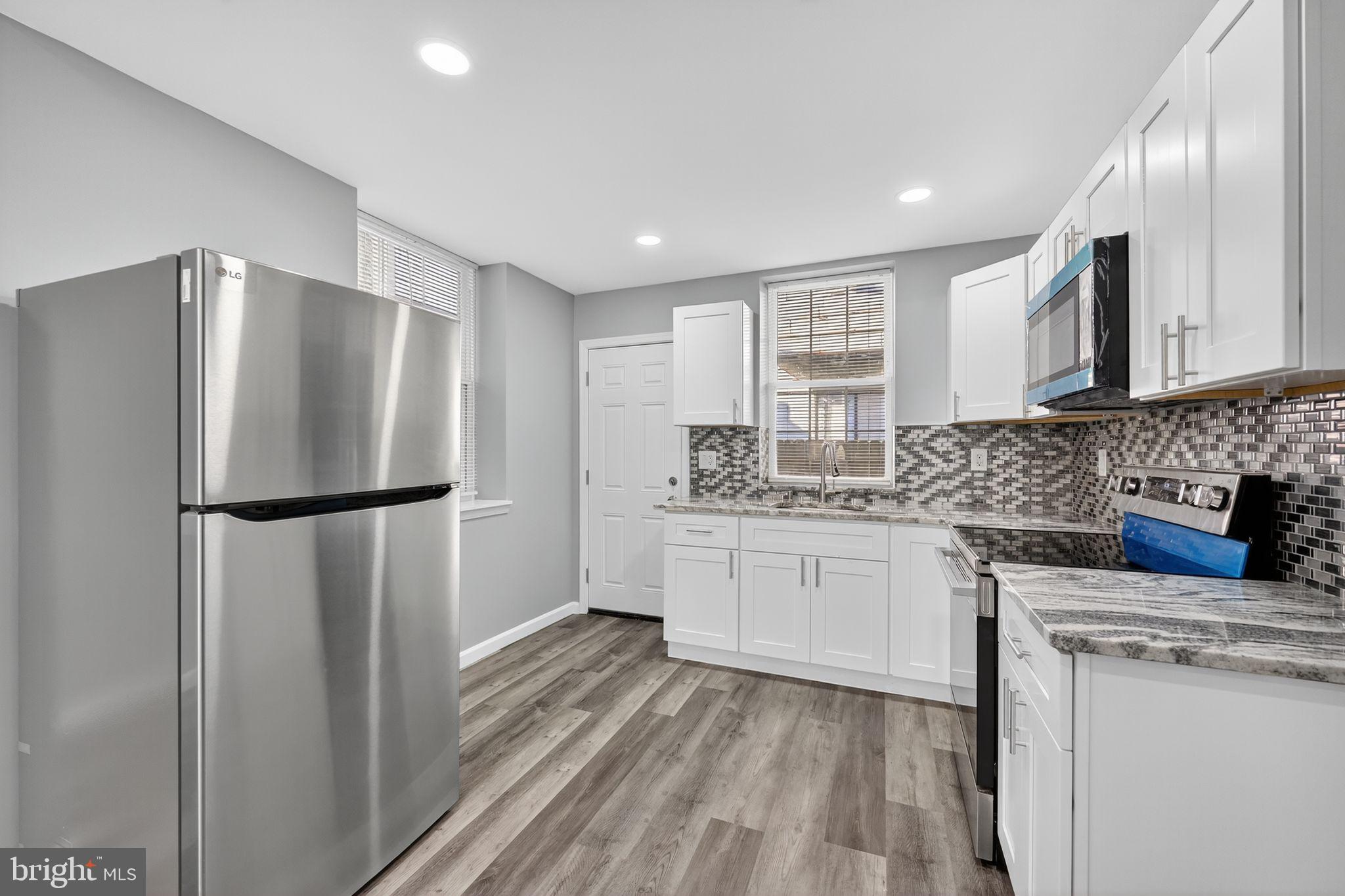 4516 North Mole Street Philadelphia, PA 19140 - Photo 11 of 30 a kitchen with stainless steel appliances a refrigerator sink microwave and cabinets