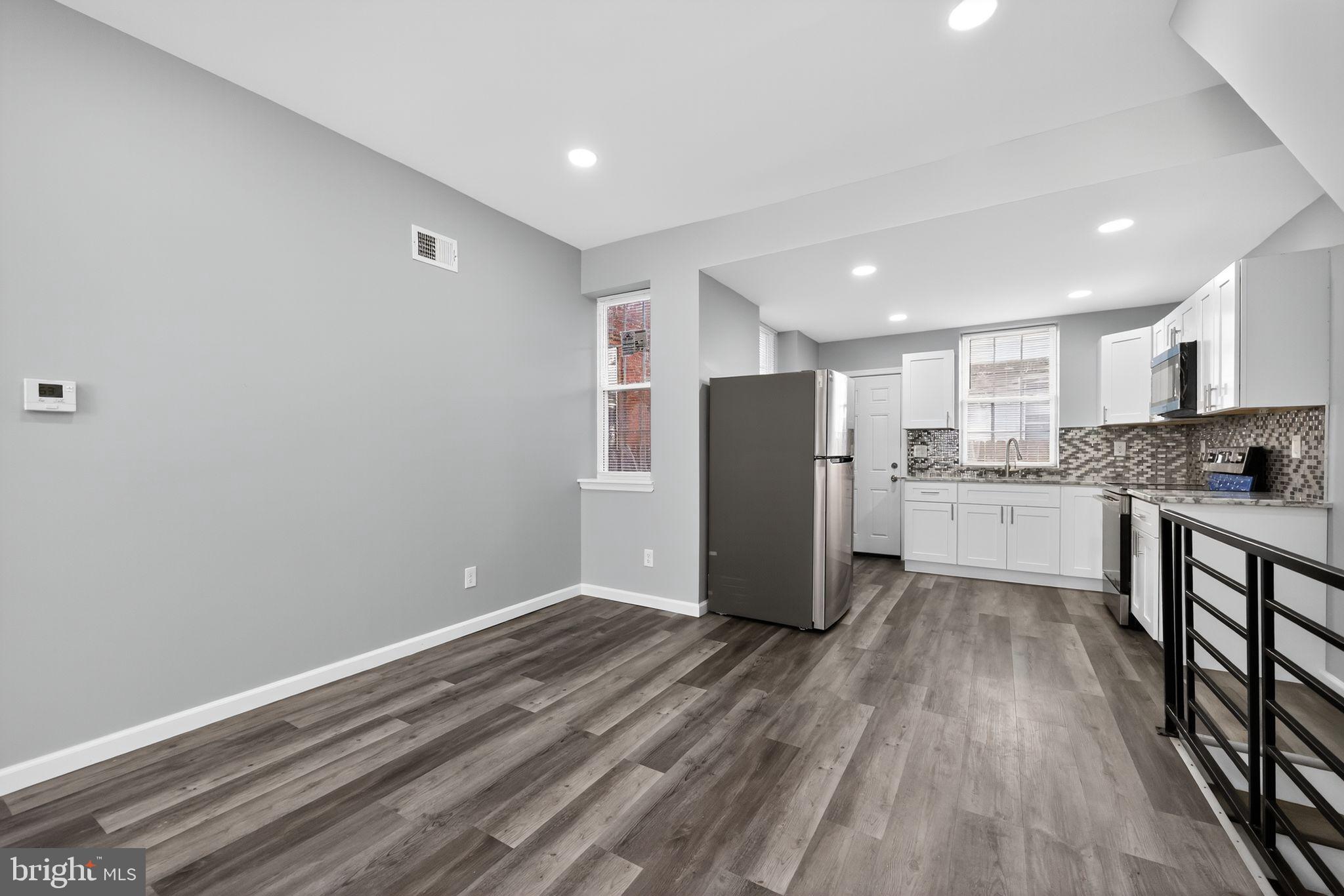 4516 North Mole Street Philadelphia, PA 19140 - Photo 12 of 30 a view of kitchen with stainless steel appliances wooden floor and a window