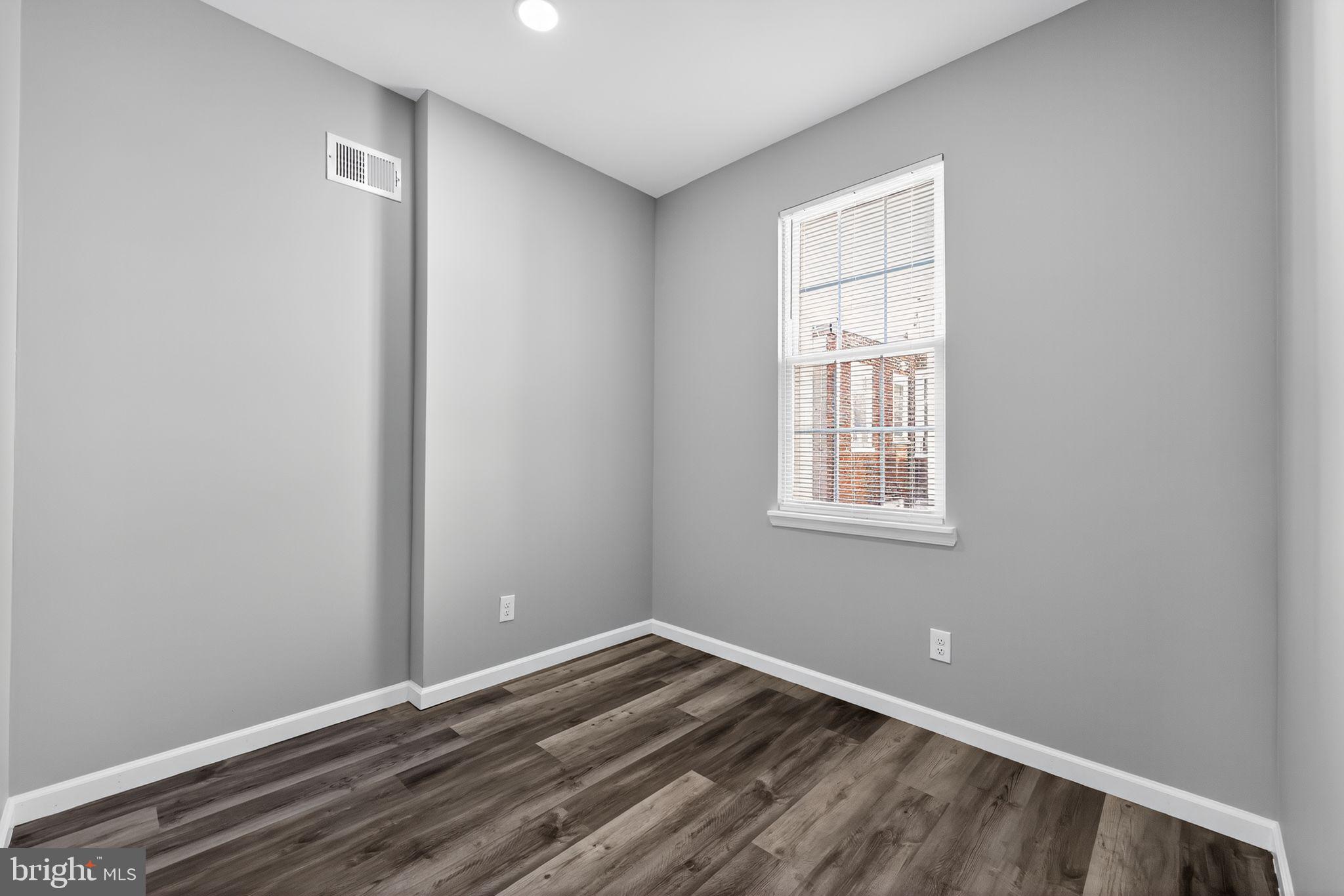 4516 North Mole Street Philadelphia, PA 19140 - Photo 16 of 30 a view of an empty room with wooden floor and a window