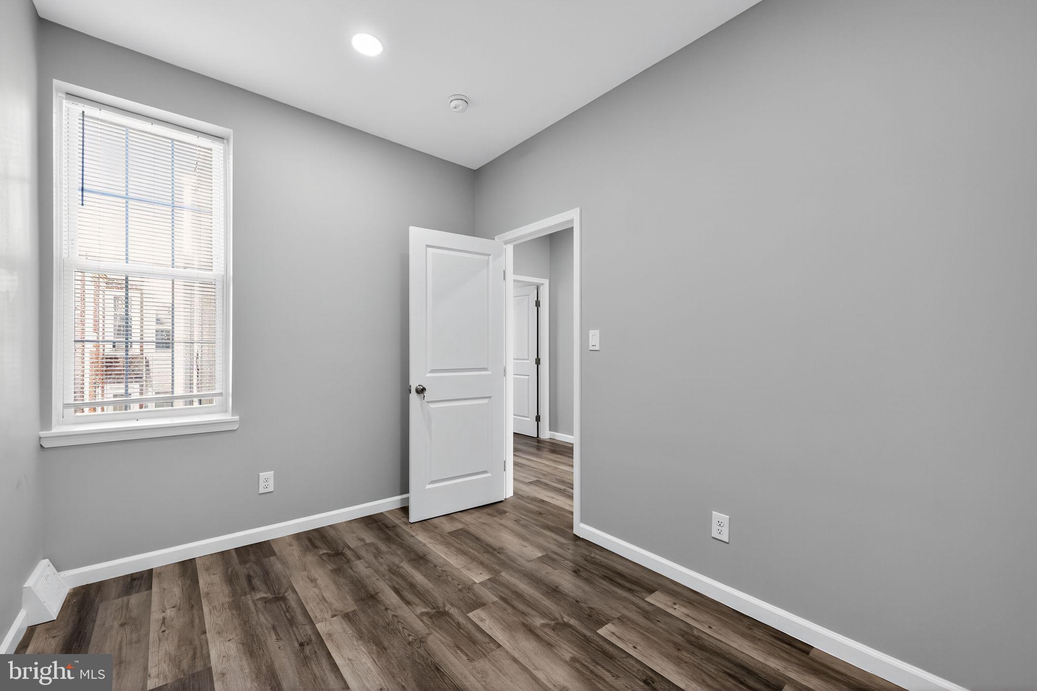 4516 North Mole Street Philadelphia, PA 19140 - Photo 18 of 30 an empty room with wooden floor and windows