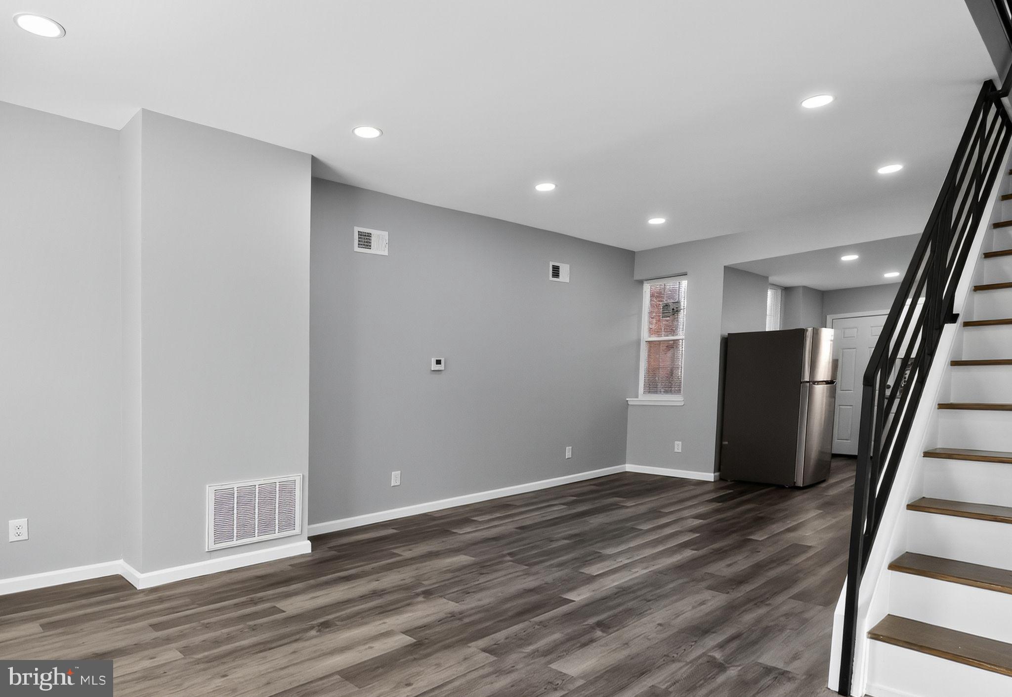 4516 North Mole Street Philadelphia, PA 19140 - Photo 26 of 30 a view of an empty room with wooden floor and stairs