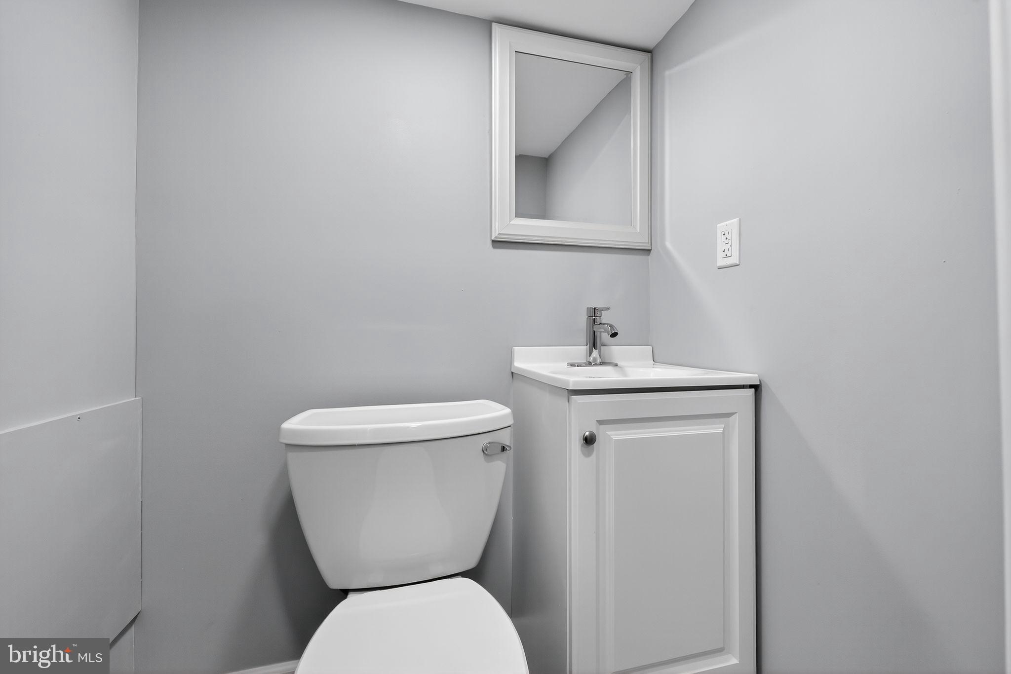 4516 North Mole Street Philadelphia, PA 19140 - Photo 28 of 30 a white toilet sitting next to a bathroom sink