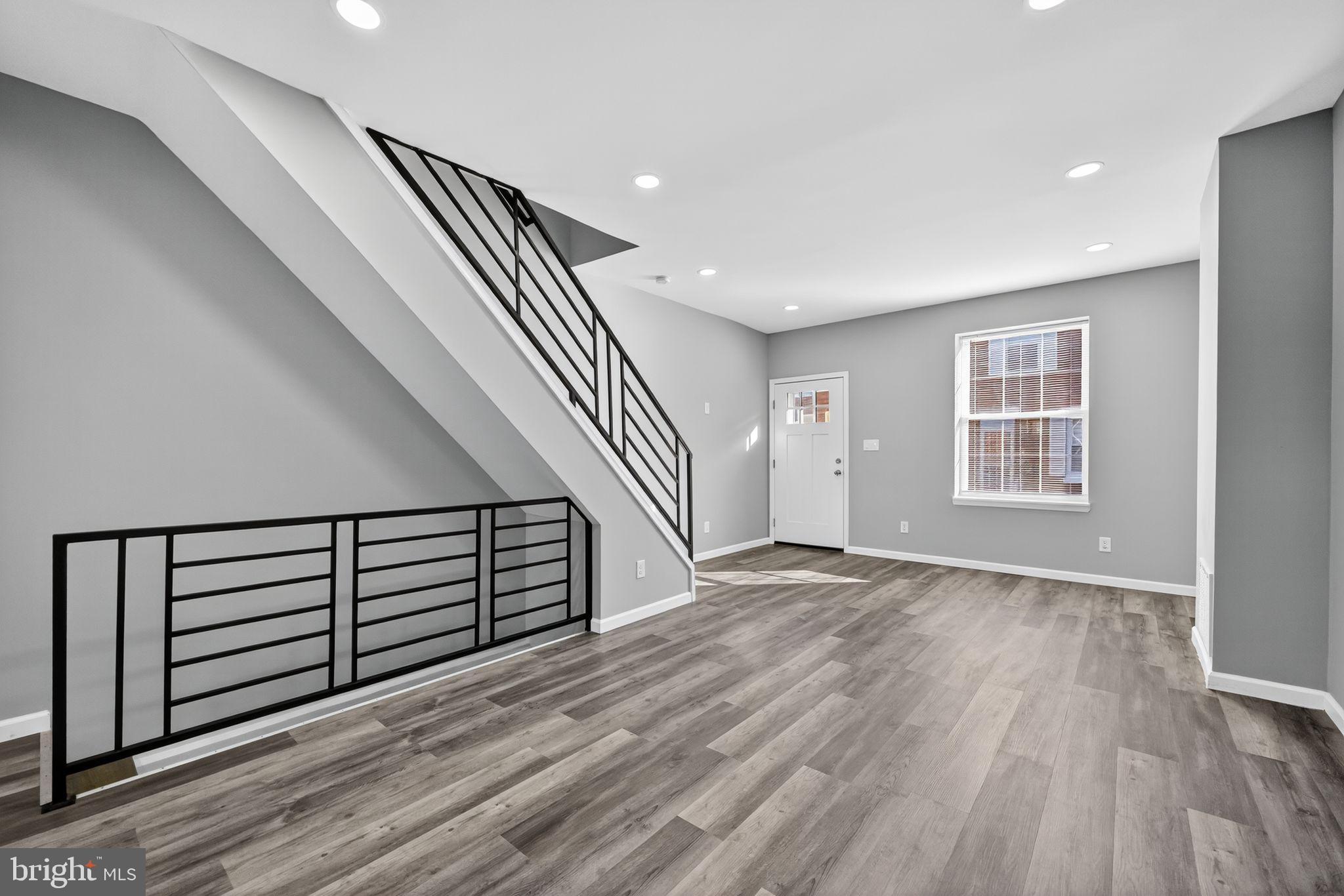 4516 North Mole Street Philadelphia, PA 19140 - Photo 4 of 30 a view of a livingroom with wooden floor and staircase