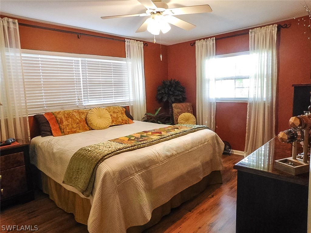 715 Riverbend Road North Fort Myers, FL 33917 - Photo 11 of 19 a bedroom with a bed and a chandelier