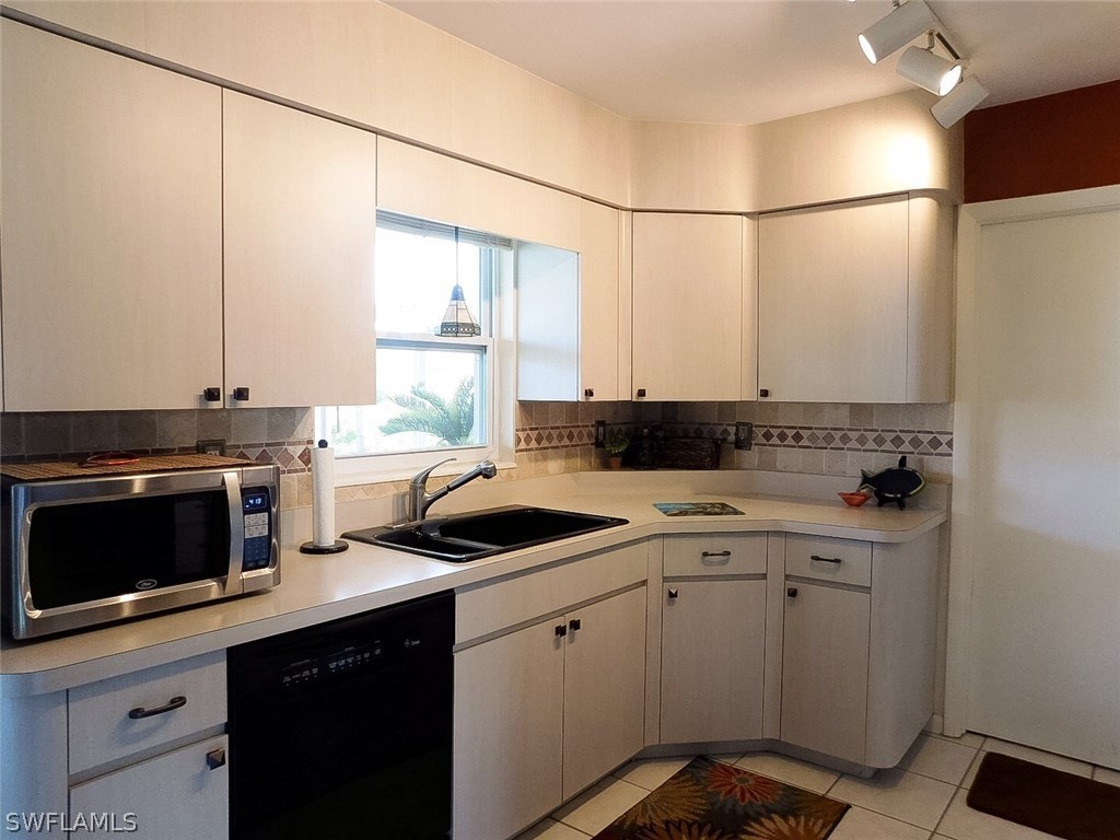 715 Riverbend Road North Fort Myers, FL 33917 - Photo 6 of 19 a kitchen with a sink cabinets and stainless steel appliances