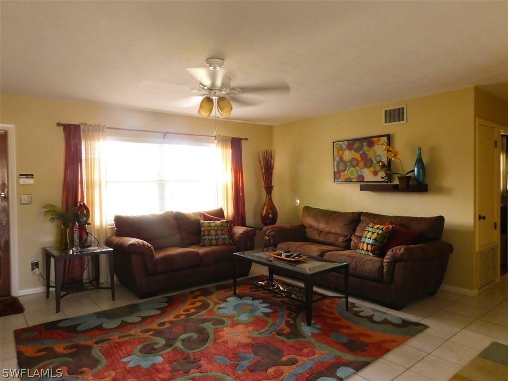 715 Riverbend Road North Fort Myers, FL 33917 - Photo 8 of 19 a living room with furniture a rug and a window