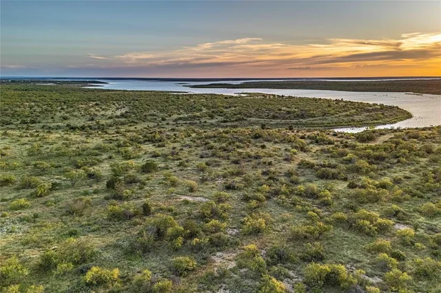 a view of a large yard with lots of green space