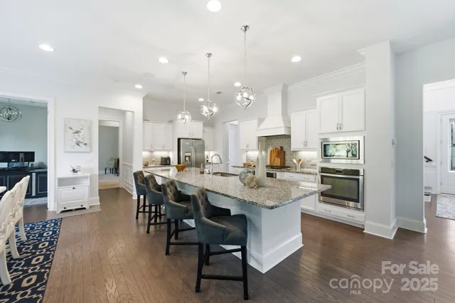 a large kitchen with stainless steel appliances lots of counter top space