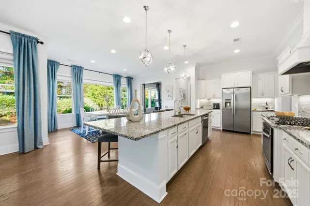 a dining room with furniture and wooden floor