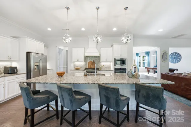 a large kitchen with granite countertop lots of counter space and window
