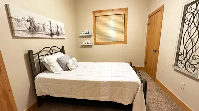 a bedroom with a bed and wall painting