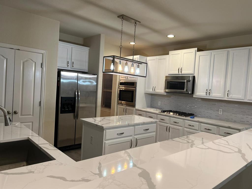 3604 Rams Horn Way Round Rock, TX 78665 - Photo 2 of 26 Culinary delights await in this bright kitchen with a spacious island and gleaming countertops.
