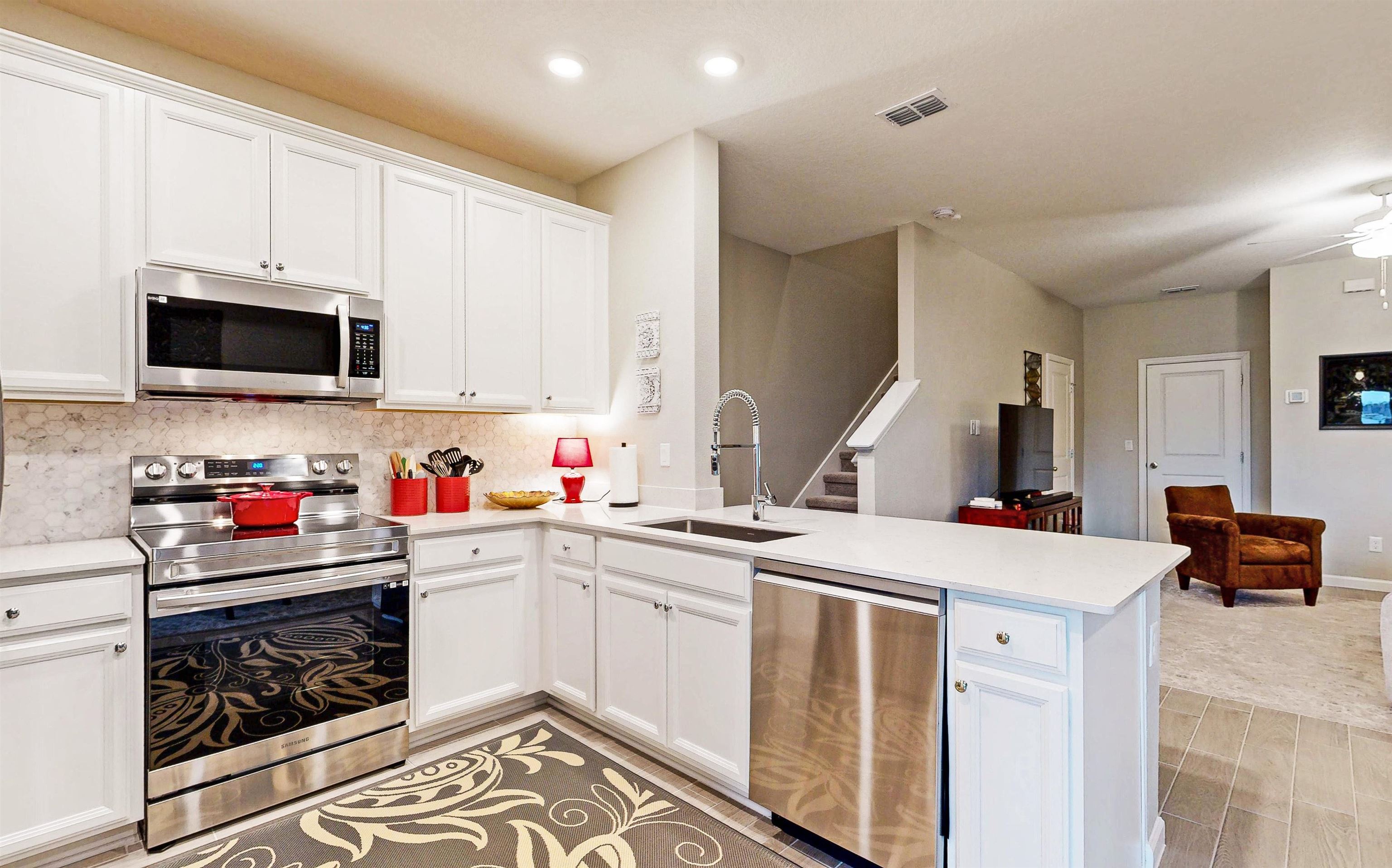 a kitchen that has a sink and a stove top oven