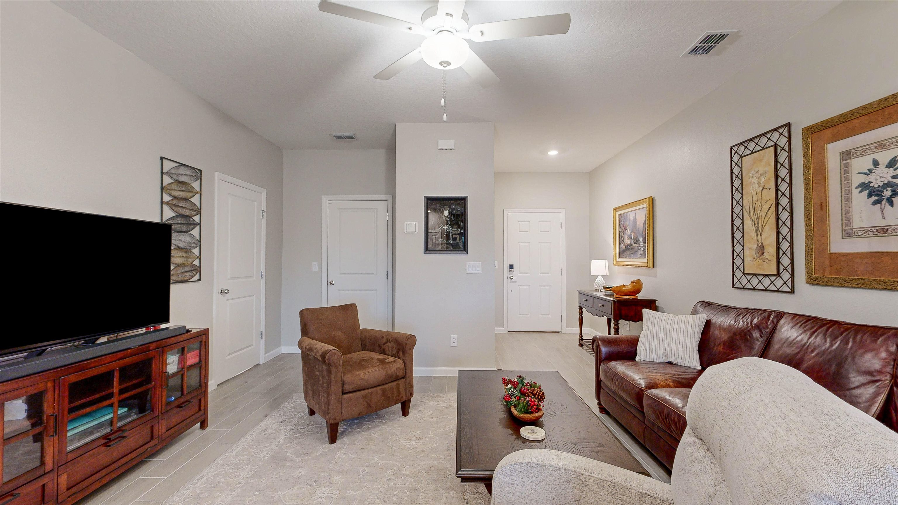 96 Bramble Court St. Augustine, FL 32092 - Photo 11 of 61 a living room with furniture and a flat screen tv