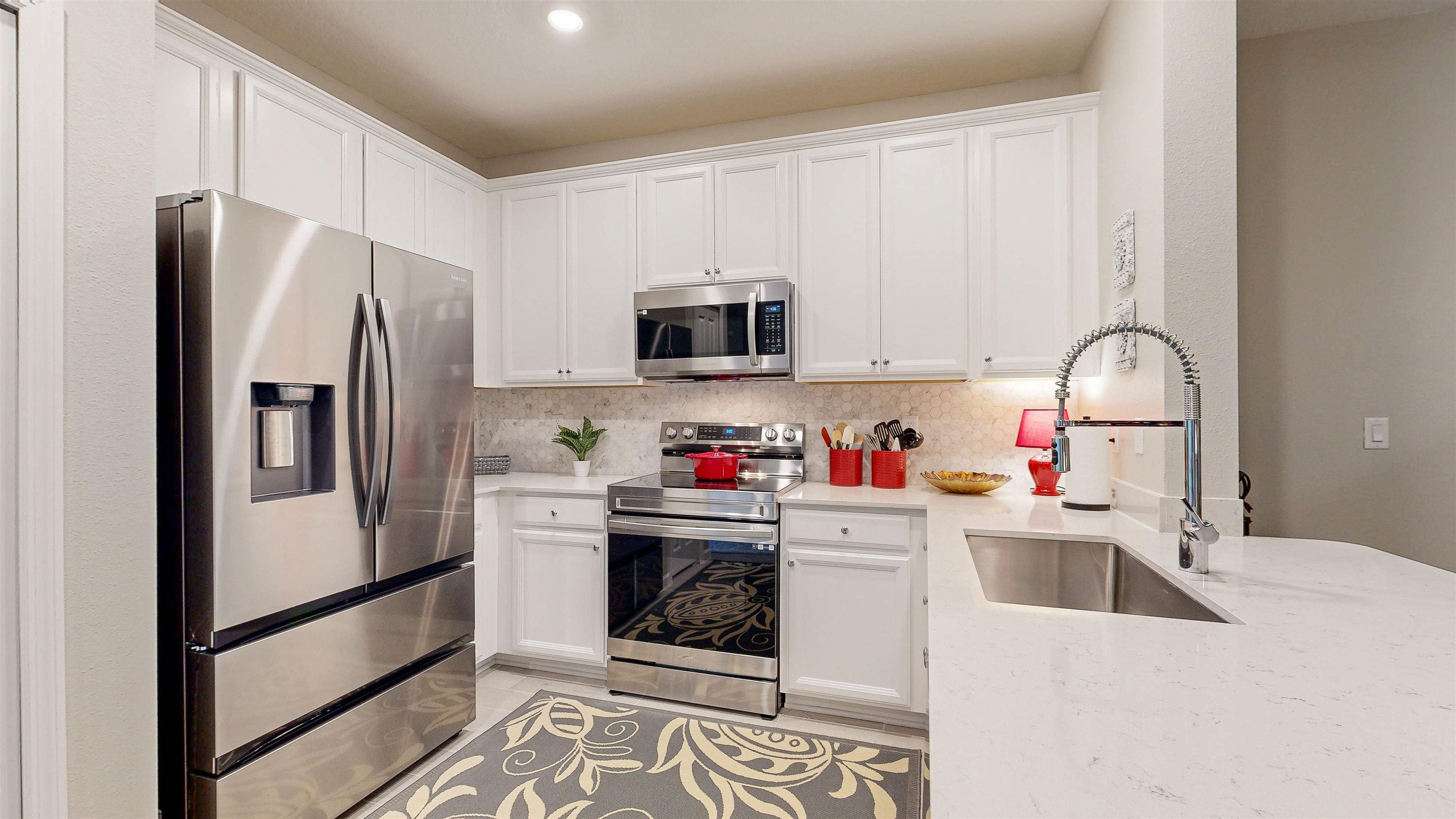 96 Bramble Court St. Augustine, FL 32092 - Photo 15 of 61 a kitchen with a sink a refrigerator and cabinets
