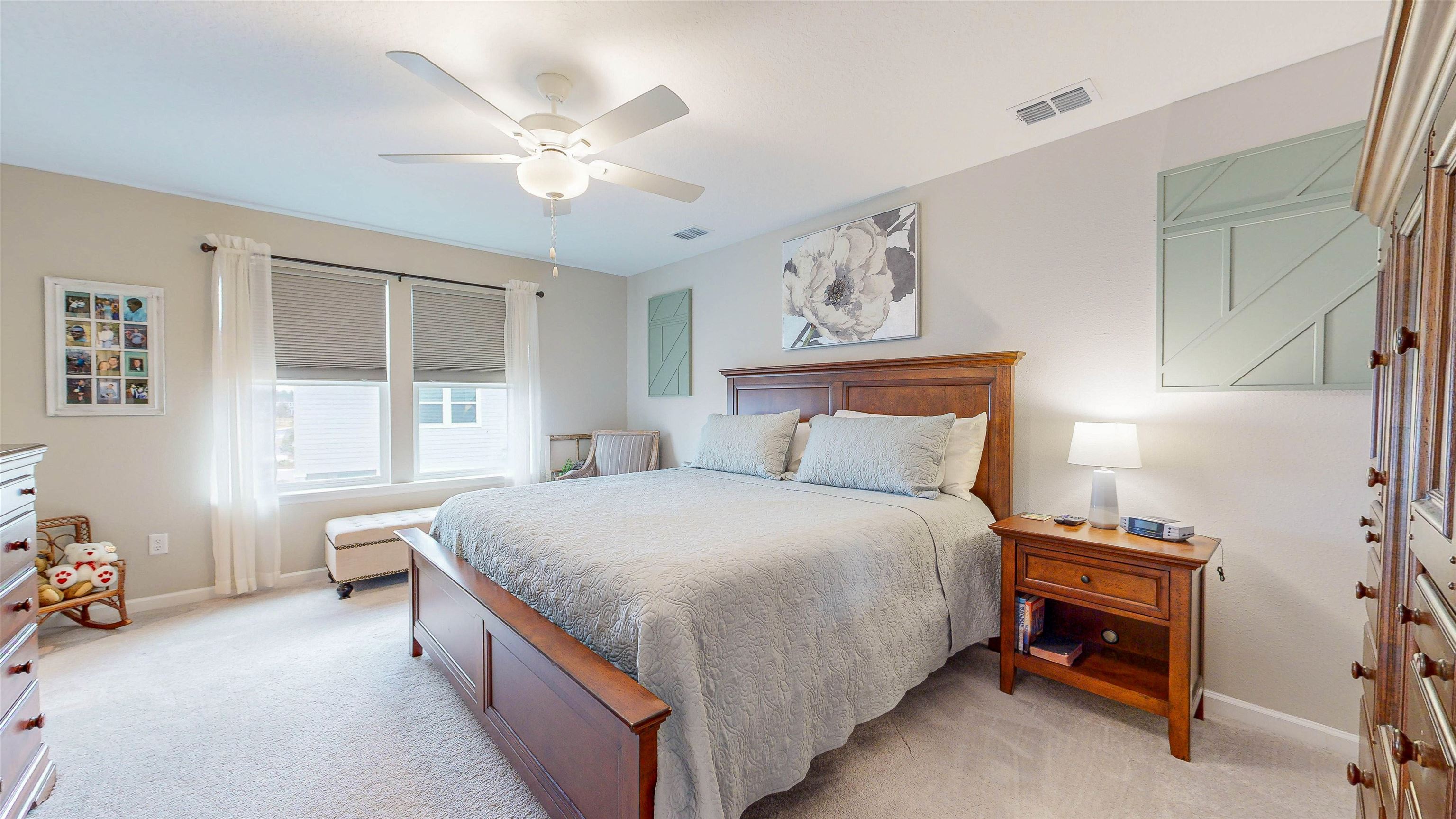96 Bramble Court St. Augustine, FL 32092 - Photo 21 of 61 a spacious bedroom with a bed and a chandelier
