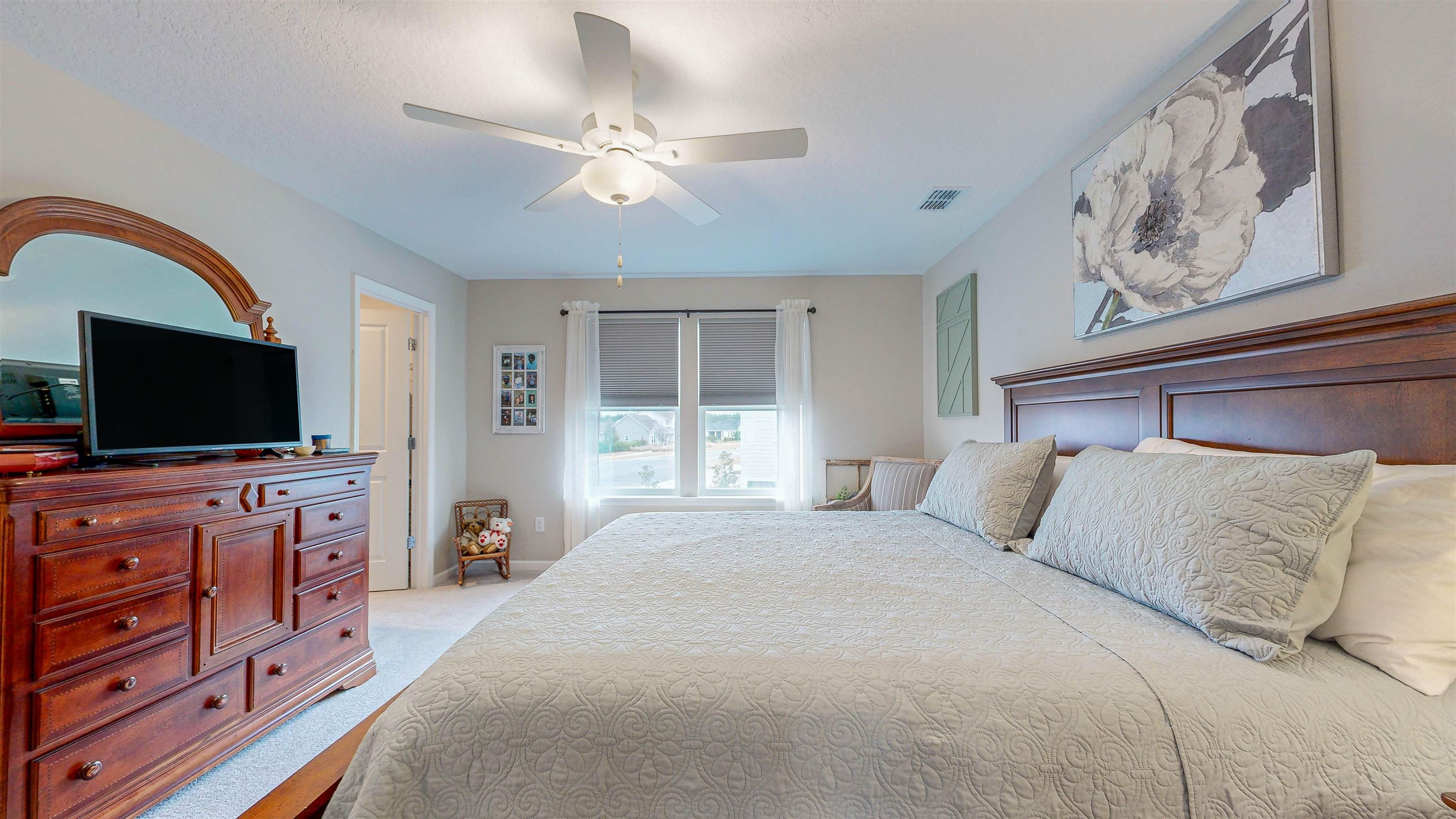 96 Bramble Court St. Augustine, FL 32092 - Photo 23 of 61 a bedroom with a large bed and a flat tv screen on dresser