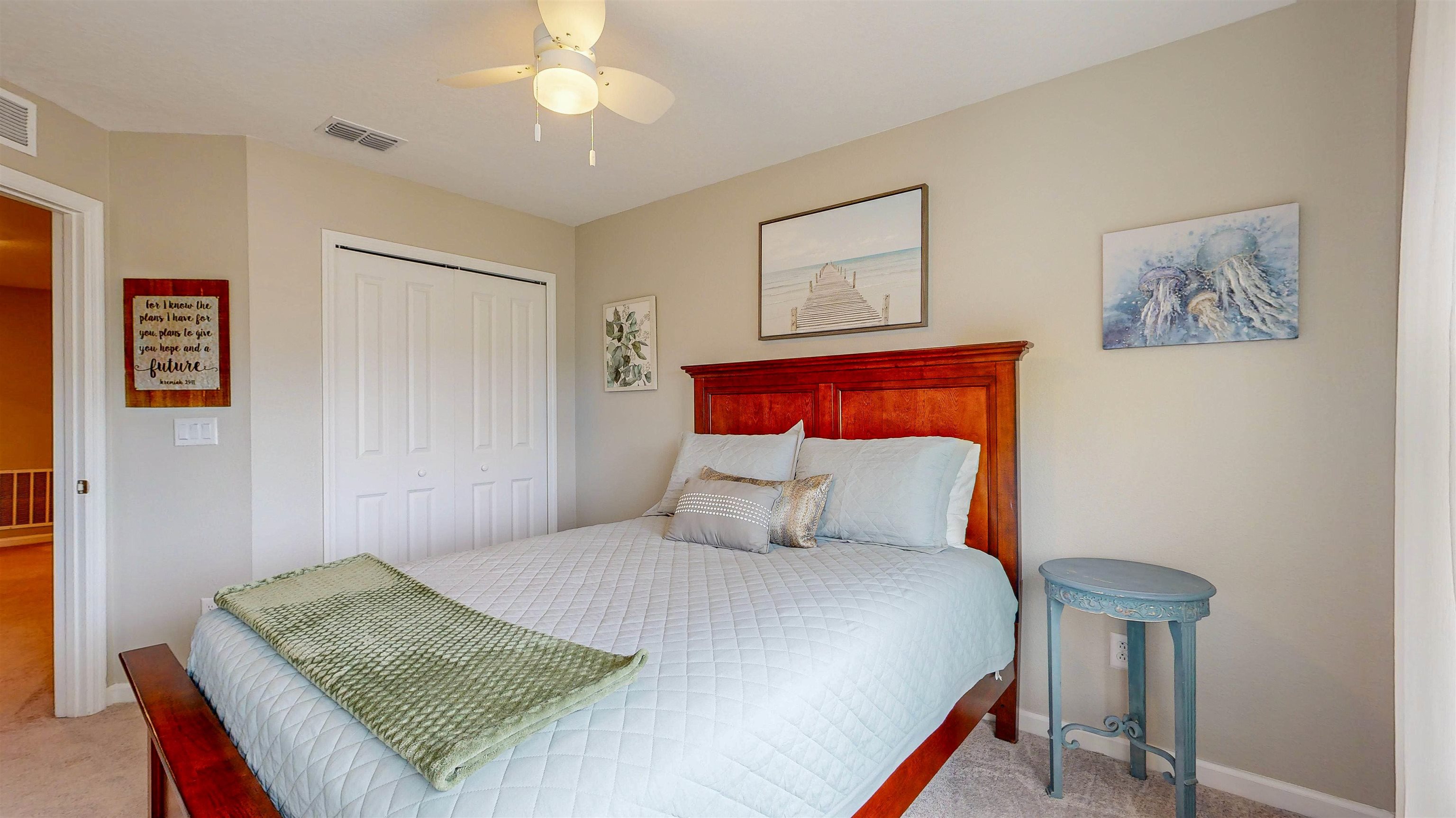 96 Bramble Court St. Augustine, FL 32092 - Photo 34 of 61 a bedroom with a bed and a chandelier