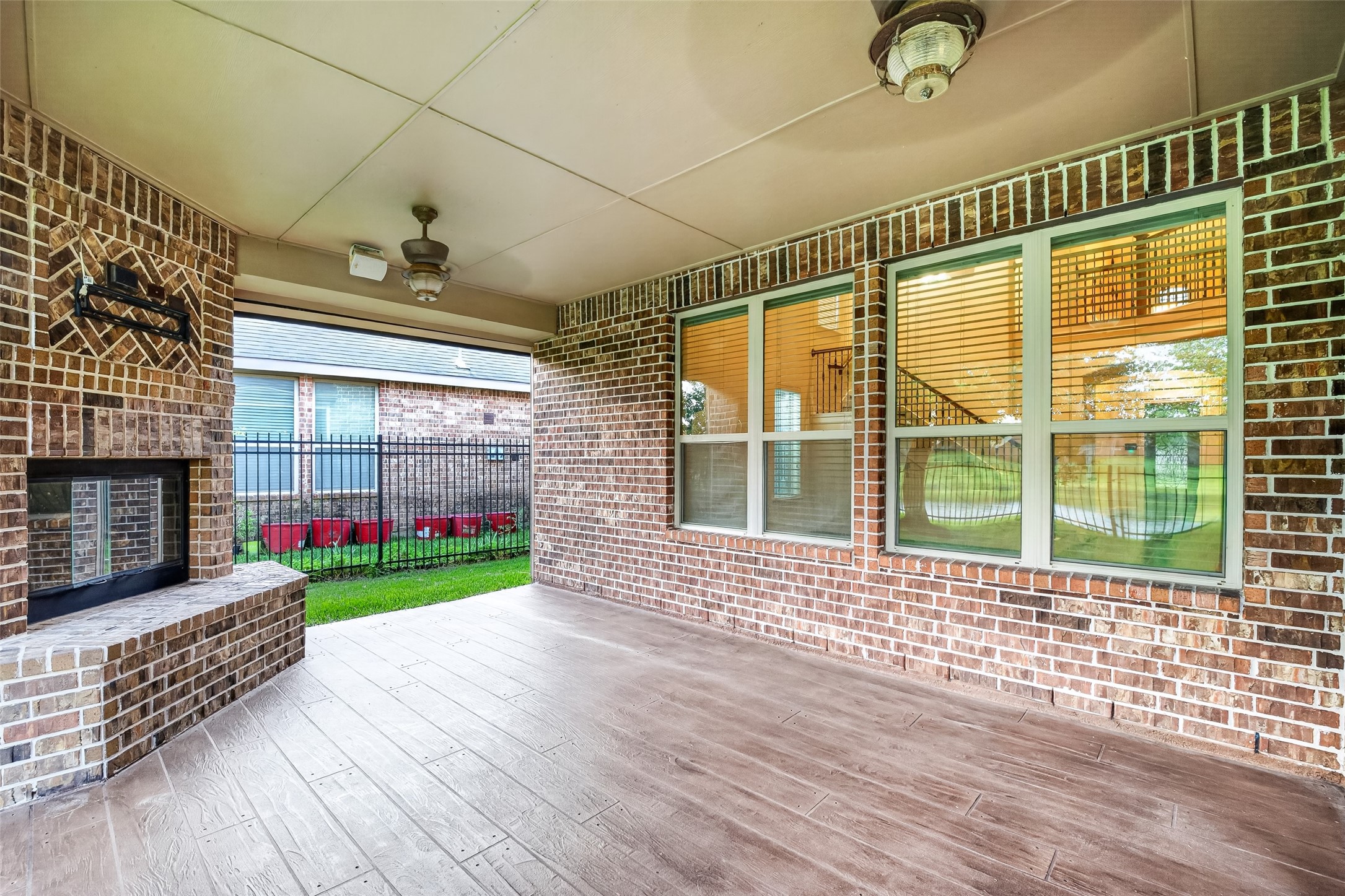 7930 Summer Night Lane Rosenberg, TX 77469 - Photo 38 of 48 Covered patio featuring an outdoor fireplace and plenty of space for year-round entertaining.