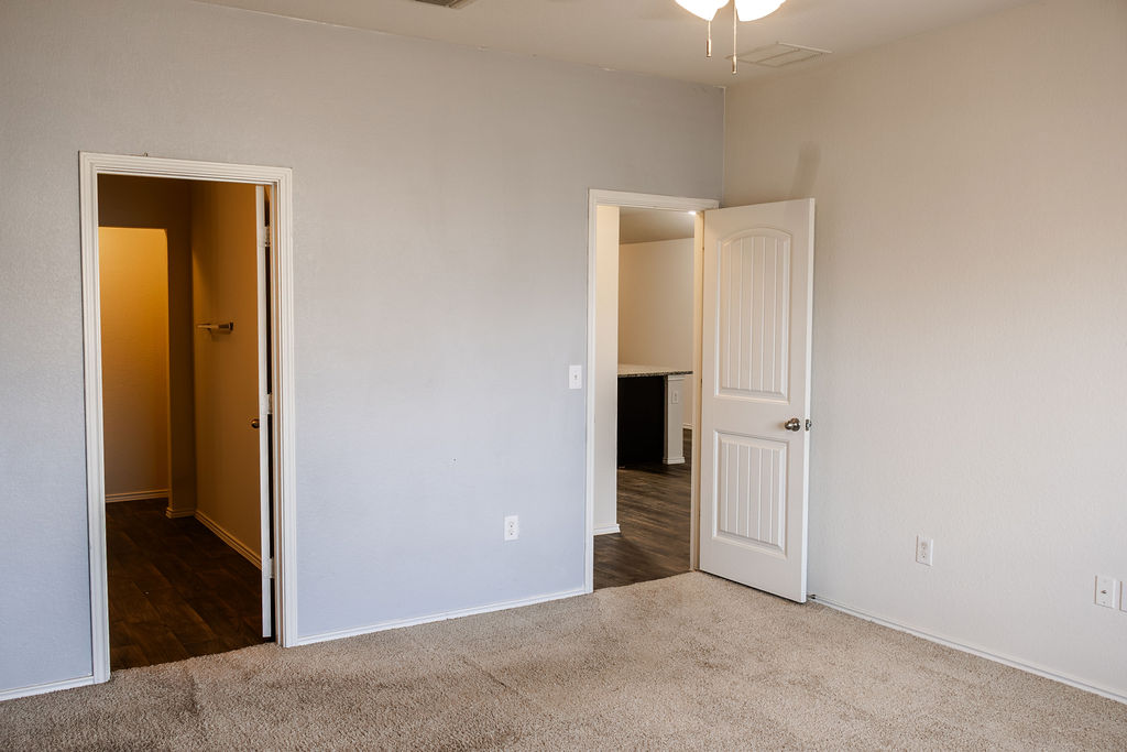 14915 Talus Road Manor, TX 78653 - Photo 12 of 20 Carpeted floors complement smooth neutral walls, opening directly to nearby living areas.