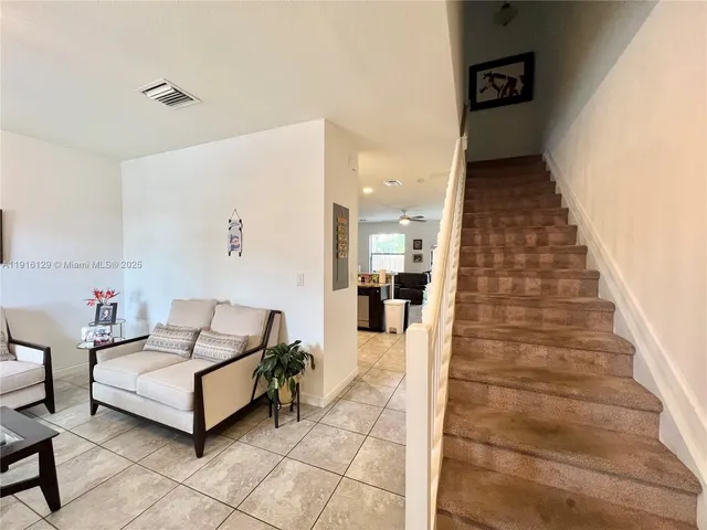 a living room with furniture and a rug