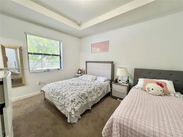 a bedroom with two beds and a window