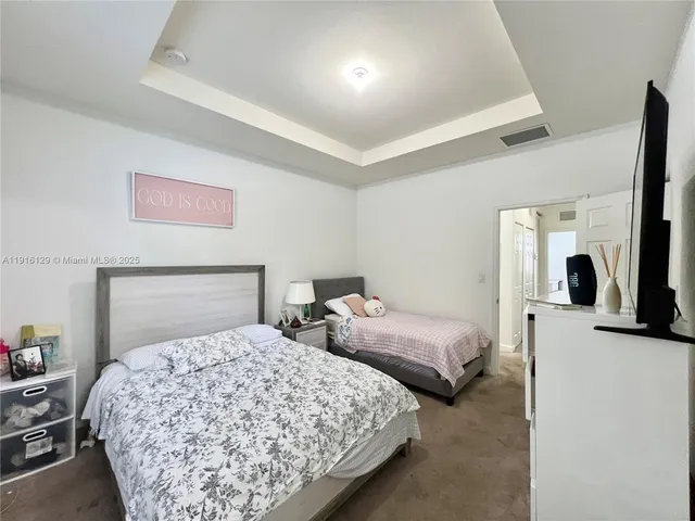 a bedroom with two beds and painted walls